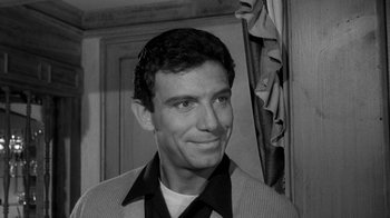 Movie still from “Period of Adjustment” (1962), directed by George Roy Hill – Black and white photograph of a man smiling for the camera; Close Up shot, Over the shoulder angle