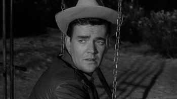 Movie still from “Period of Adjustment” (1962), directed by George Roy Hill – A black and white photo of a man wearing a cowboy hat; Close Up shot, High angle