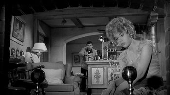 Movie still from “Period of Adjustment” (1962), directed by George Roy Hill – A man and a woman in a living room; Medium shot, Low angle
