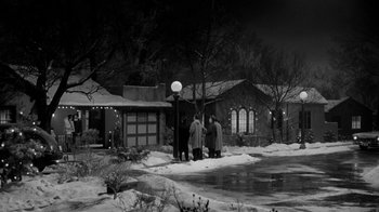 Movie still from “Period of Adjustment” (1962), directed by George Roy Hill – A group of people standing in front of a house; Extreme Wide shot, High angle