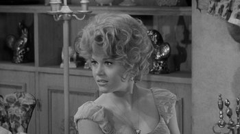 Movie still from “Period of Adjustment” (1962), directed by George Roy Hill – A black and white photo of a woman in a dress; Close Up shot, Over the shoulder angle