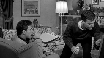 Movie still from “Period of Adjustment” (1962), directed by George Roy Hill – Two men sitting in a living room drinking coffee; Medium shot, Over the shoulder angle
