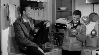 Movie still from “Period of Adjustment” (1962), directed by George Roy Hill – Two men sitting in a kitchen drinking wine; Medium shot, Low angle