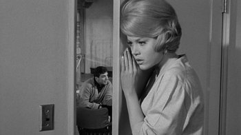Movie still from “Period of Adjustment” (1962), directed by George Roy Hill – A man and a woman in a room with a door open; Medium shot, Over the shoulder angle