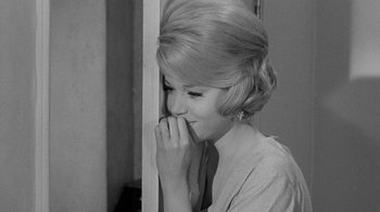 Movie still from “Period of Adjustment” (1962), directed by George Roy Hill – A woman with her hands over her mouth; Close Up shot, Over the shoulder angle