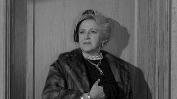 Movie still from “Period of Adjustment” (1962), directed by George Roy Hill – An older woman wearing a hat and a fur coat; Close Up shot, Over the shoulder angle