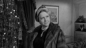 Movie still from “Period of Adjustment” (1962), directed by George Roy Hill – An older woman wearing a fur coat and a hat; Close Up shot, Over the shoulder angle