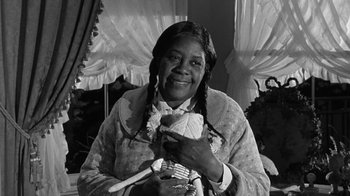 Movie still from “Period of Adjustment” (1962), directed by George Roy Hill – An older woman holding a stuffed animal in her hands; Close Up shot, Low angle