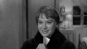 Movie still from “Period of Adjustment” (1962), directed by George Roy Hill – A black - and - white photo of a woman in a fur coat; Close Up shot, Over the shoulder angle