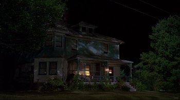 Movie still from “Pet Sematary” (1989), directed by Mary Lambert – An old house is lit up at night time; Extreme Wide shot, Low angle