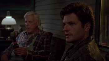 Movie still from “Pet Sematary” (1989), directed by Mary Lambert – A man and a man sitting on a chair; Close Up shot, Over the shoulder angle