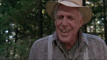 Movie still from “Pet Sematary” (1989), directed by Mary Lambert – An older man wearing a cowboy hat smiling for the camera; Close Up shot, Low angle