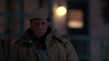 Movie still from “Pet Sematary” (1989), directed by Mary Lambert – An older man wearing a hat and a jacket; Medium shot, Over the shoulder angle