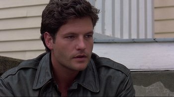 Movie still from “Pet Sematary” (1989), directed by Mary Lambert – A person wearing a leather jacket; Close Up shot, Low angle