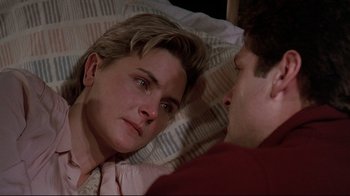 Movie still from “Pet Sematary” (1989), directed by Mary Lambert – A man and a woman laying in a bed together; Close Up shot, High angle