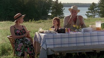 Movie still from “Pet Sematary” (1989), directed by Mary Lambert – A group of people sitting at a table with food; Wide shot, Over the shoulder angle
