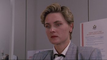 Movie still from “Pet Sematary” (1989), directed by Mary Lambert – A person wearing a suit and tie; Close Up shot, Over the shoulder angle