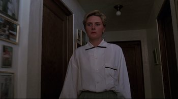 Movie still from “Pet Sematary” (1989), directed by Mary Lambert – A man in a white shirt and green pants; Medium shot, Low angle