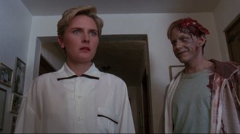 Movie still from “Pet Sematary” (1989), directed by Mary Lambert – A woman standing next to another woman in a room; Close Up shot, Low angle