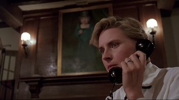 Movie still from “Pet Sematary” (1989), directed by Mary Lambert – A man talking on a phone in front of a painting; Close Up shot, Low angle