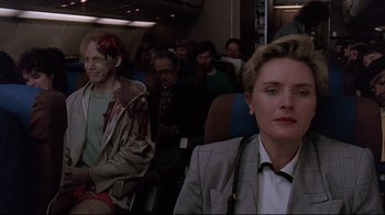 Movie still from “Pet Sematary” (1989), directed by Mary Lambert – A man and a woman sitting on a plane; Medium shot, Over the shoulder angle