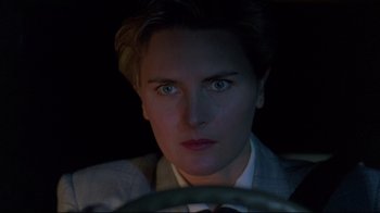 Movie still from “Pet Sematary” (1989), directed by Mary Lambert – A woman sitting in the drivers seat of a car; Close Up shot, Over the shoulder angle