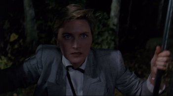 Movie still from “Pet Sematary” (1989), directed by Mary Lambert – A man in a suit and tie in the dark; Close Up shot, High angle
