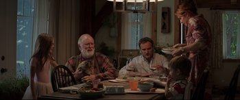 Movie still from “Pet Sematary” (2019), directed by Kevin Kölsch – A group of people sitting at a table with food; Medium shot, Over the shoulder angle