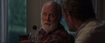 Movie still from “Pet Sematary” (2019), directed by Kevin Kölsch – An older man with a beard and a mustache; Close Up shot, Over the shoulder angle