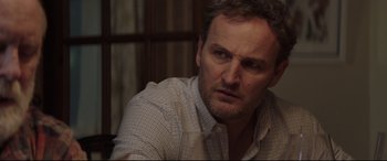 Movie still from “Pet Sematary” (2019), directed by Kevin Kölsch – A person sitting at a table; Close Up shot, Over the shoulder angle