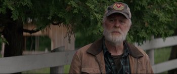 Movie still from “Pet Sematary” (2019), directed by Kevin Kölsch – An older man with a beard wearing a hat; Close Up shot, Over the shoulder angle