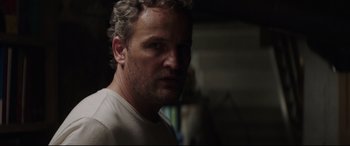 Movie still from “Pet Sematary” (2019), directed by Kevin Kölsch – A person wearing a white t - shirt; Close Up shot, Low angle