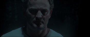 Movie still from “Pet Sematary” (2019), directed by Kevin Kölsch – A person wearing a white t - shirt; Close Up shot, Low angle