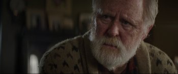 Movie still from “Pet Sematary” (2019), directed by Kevin Kölsch – An old man with a beard and a mustache; Close Up shot, Over the shoulder angle