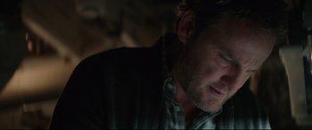 Movie still from “Pet Sematary” (2019), directed by Kevin Kölsch – A man's face in the dark; Close Up shot, Over the shoulder angle