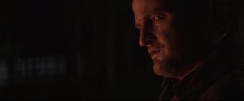 Movie still from “Pet Sematary” (2019), directed by Kevin Kölsch – A man's face in the dark; Close Up shot, Over the shoulder angle