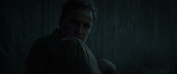 Movie still from “Pet Sematary” (2019), directed by Kevin Kölsch – A man in a dark room holding something in front of him; Close Up shot, Low angle