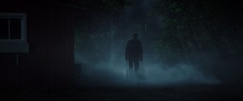 Movie still from “Pet Sematary” (2019), directed by Kevin Kölsch – A man standing in the middle of a forest at night; Wide shot, Low angle
