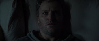 Movie still from “Pet Sematary” (2019), directed by Kevin Kölsch – A man's face in the dark; Close Up shot, Low angle