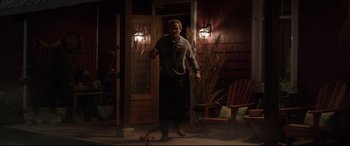 Movie still from “Pet Sematary” (2019), directed by Kevin Kölsch – A man standing in front of a house at night; Wide shot, High angle