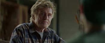 Movie still from “Pete's Dragon” (2016), directed by David Lowery – An older man with a messy hair style; Close Up shot, Low angle