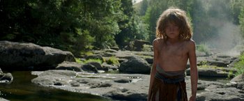 Movie still from “Pete's Dragon” (2016), directed by David Lowery – A young girl standing next to a river; Medium shot, Low angle