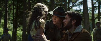 Movie still from “Pete's Dragon” (2016), directed by David Lowery – A woman and two men in the woods talking to a child; Medium shot, Over the shoulder angle