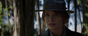 Movie still from “Pete's Dragon” (2016), directed by David Lowery – A person wearing a hat near a tree; Close Up shot, Low angle