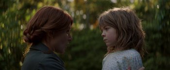 Movie still from “Pete's Dragon” (2016), directed by David Lowery – A woman and a girl face to face in a forest; Close Up shot, Over the shoulder angle