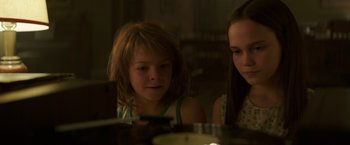 Movie still from “Pete's Dragon” (2016), directed by David Lowery – Two young girls are looking at a tablet; Close Up shot, Low angle