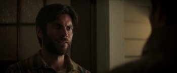 Movie still from “Pete's Dragon” (2016), directed by David Lowery – A person with a beard looking at the camera; Close Up shot, Over the shoulder angle