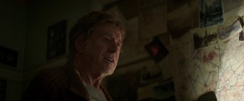 Movie still from “Pete's Dragon” (2016), directed by David Lowery – An older man with a beard and a sweater; Close Up shot, Over the shoulder angle