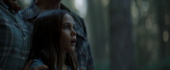 Movie still from “Pete's Dragon” (2016), directed by David Lowery – A young girl looking up at the sky; Close Up shot, Low angle