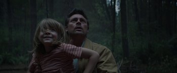 Movie still from “Pete's Dragon” (2016), directed by David Lowery – A man and a little girl in the woods; Close Up shot, Low angle